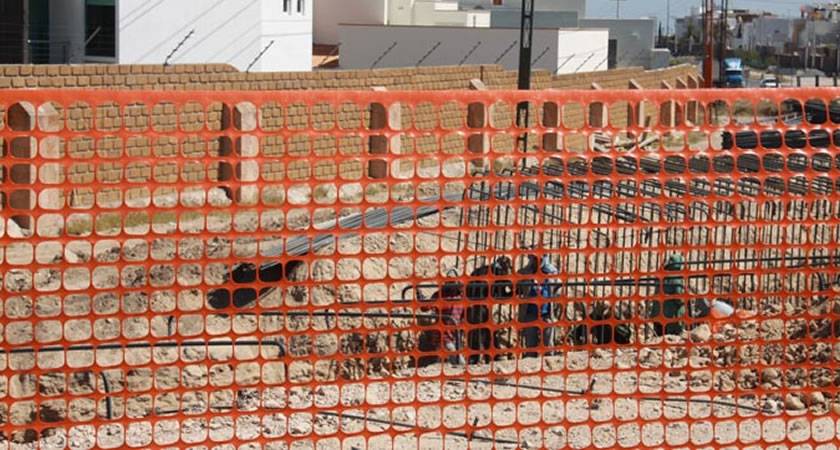 Orange plastic barrier fence for construction sites.