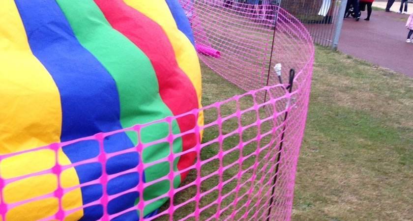 Pink barrier mesh at sport event.